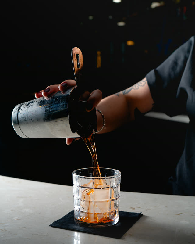 Bartender pouring a craft cocktail