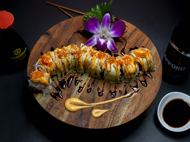 Dragon roll on wooden board