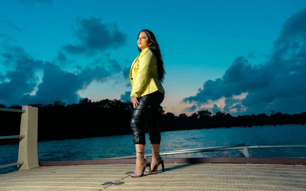 Portrait at sunset dock — yellow blazer